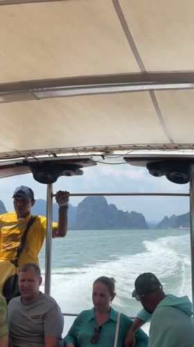 Passenger boat travels through Thai waters near mountains