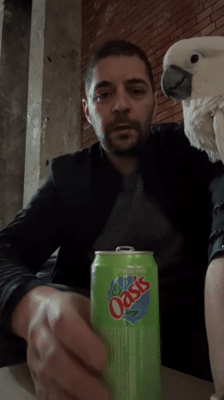 Man shares drink with cockatoo in Tanger