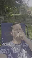 Man enjoys leisurely morning smoking and taking selfies in London yard