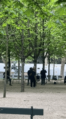 Parisians enjoy typical afternoon park activities under cloudy skies