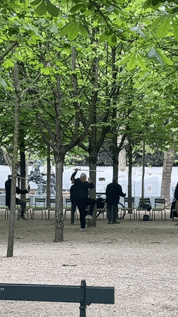 Parisians enjoy typical afternoon park activities under cloudy skies