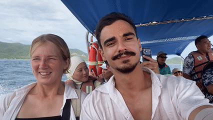 On a Nha Trang tour boat, passengers film and laugh at sea