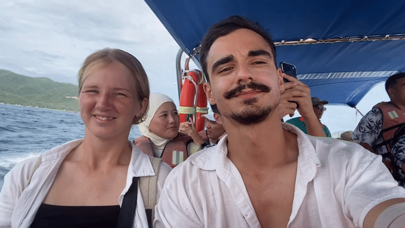 On a Nha Trang tour boat, passengers film and laugh at sea