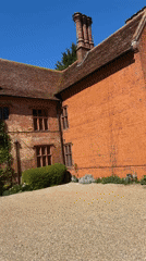 Ivy-covered brick building observed in Sutton during sunny day