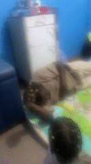 Adult and child share playtime on mat in Port-Harcourt