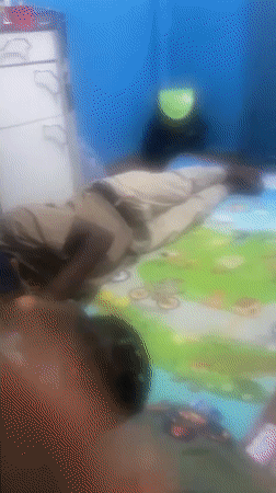 Adult and child share playtime on mat in Port-Harcourt