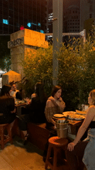 Young adults socialize at outdoor Tel Aviv bar