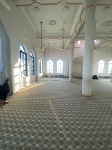 Prayer session documented at Kandahar mosque with traditional refreshments