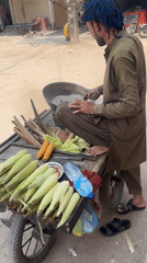 Street corn vendor serves morning customers in Multan Pakistan