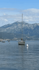 Sailboat anchored in Montenegro bay among other vessels