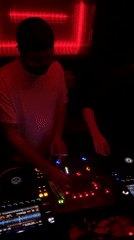 Two DJs perform at Tel Aviv nightclub under red lighting