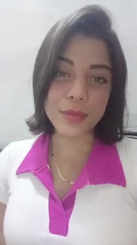 Woman smiles, brushes hair in Tinaquillo, Venezuela