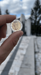Commemorative Levski coin displayed on historic Bansko street