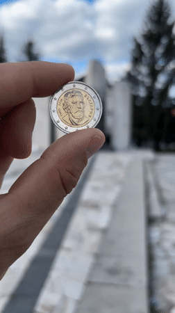 Commemorative Levski coin displayed on historic Bansko street