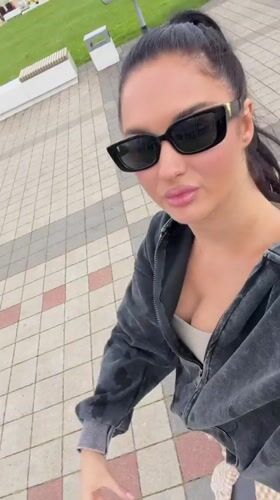 Woman takes casual selfie on pathway in Novorossiysk