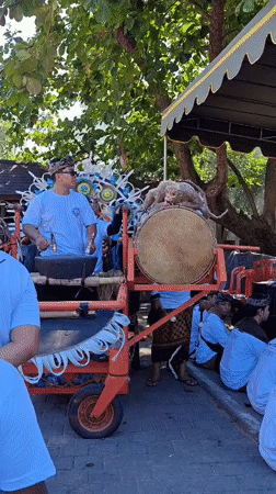 Traditional Balinese funeral procession observed in Denpasar streets