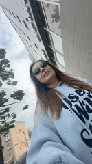 Woman playfully sticks tongue out at camera in Perm