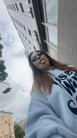 Woman playfully sticks tongue out at camera in Perm