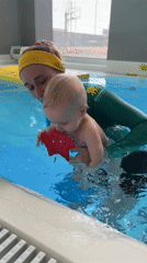 Woman teaches baby to swim in Khimki pool