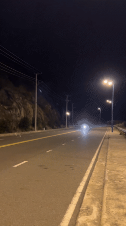 Night motorcycle riders spotted on cliff road in Vietnam