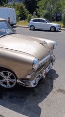 Fresh produce and a vintage car at a Bishkek morning market