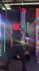 Arcade gamer plays hammer-striking game in London