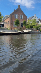 Sunny canal scene captured in Katwijk with moored boats