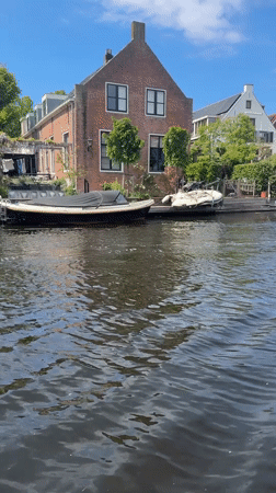 Sunny canal scene captured in Katwijk with moored boats
