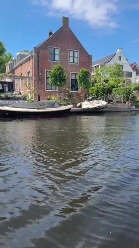 Sunny canal scene captured in Katwijk with moored boats