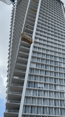 Crane lifts crate up Tel Aviv building side