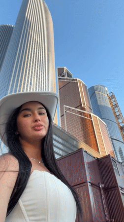 Woman Takes Selfie Against Khimki Skyline on Clear Day