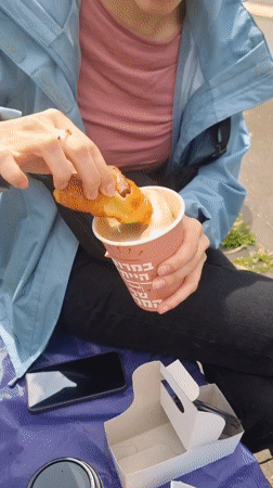 Woman enjoys outdoor breakfast with croissant and coffee