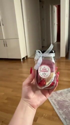 Woman displays decorative 'Love Jar' keepsake in Esenyurt, Turkey