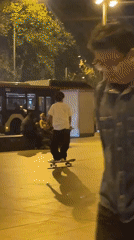 Nighttime skateboarding session captured in illuminated Barcelona plaza