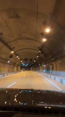 Vehicle drives through illuminated tunnel in Razdolnoye, Russia