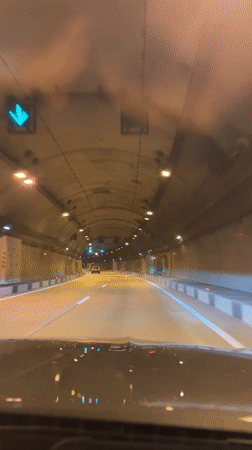 Vehicle drives through illuminated tunnel in Razdolnoye, Russia