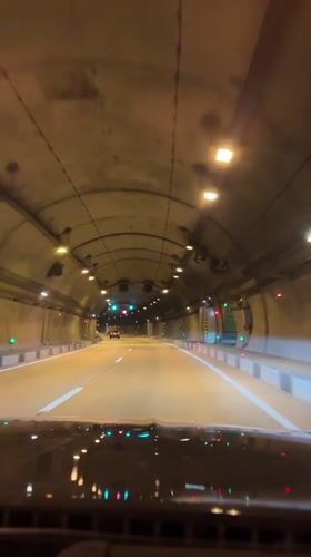Vehicle drives through illuminated tunnel in Razdolnoye, Russia