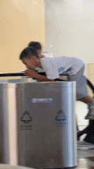 Boys play on mall trash bin, escalator in Futian