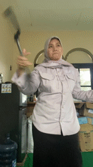 Goofing around with a broom on a government workday in Banjarbaru
