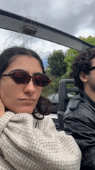 Woman records selfie video in open-air vehicle, Gondarém Portugal
