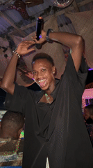 Nighttime social gathering with live music documented in Ado