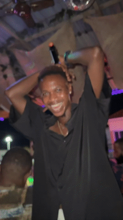 Nighttime social gathering with live music documented in Ado
