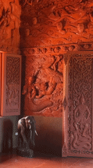 Ornate red temple carvings documented in Baan Hua Thanon