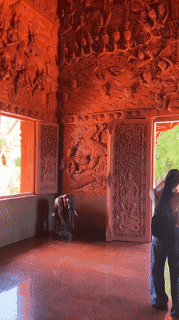 Ornate red temple carvings documented in Baan Hua Thanon