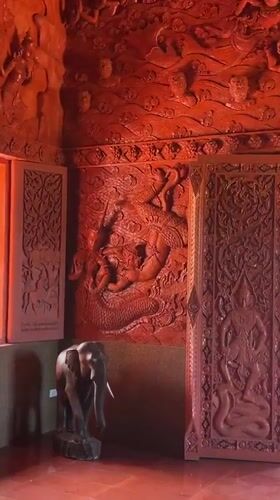 Ornate red temple carvings documented in Baan Hua Thanon