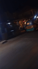Person stands near truck on dimly lit Nigerian street