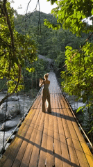 Suspension bridge and river play in forested Ranong