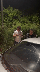 Three men gather at night near car in Zlatograd
