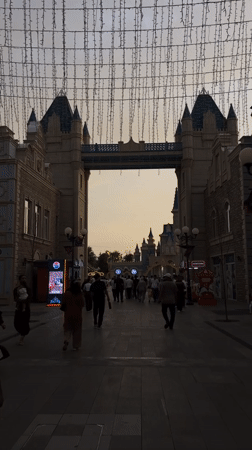 Evening crowds gather at illuminated entertainment complex in Tashkent