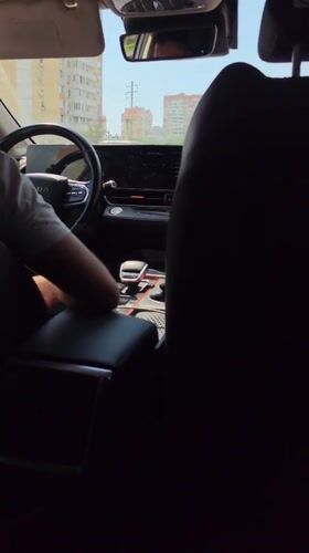 Rear passenger view inside a moving car